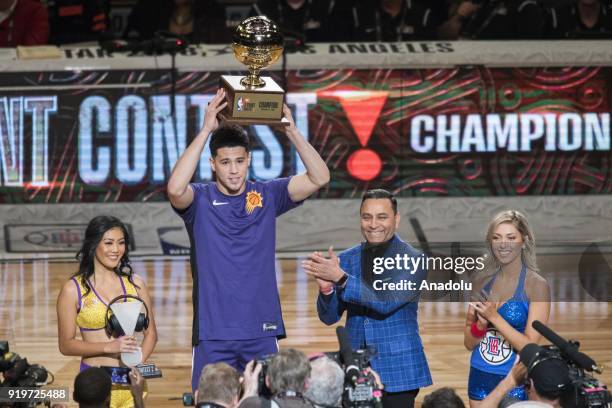 Devin Booker of the Phoenix Suns holds the trophy after winning the JBL Three-Point Contest during State Farm All-Star Saturday Night, as part of...