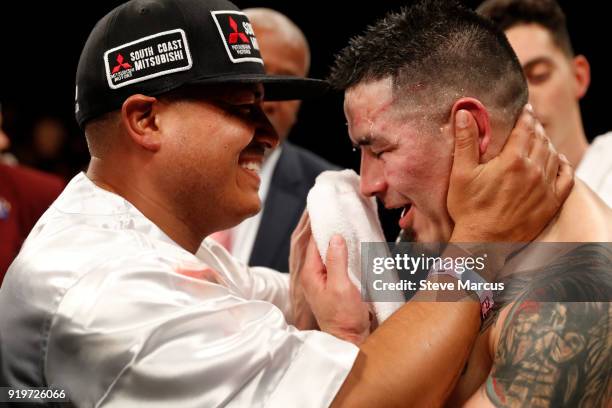 Trainer Robert Garcia embraces Brandon Rios after his loss to Danny Garcia in a welterweight bout at the Mandalay Bay Events Center on February 17,...