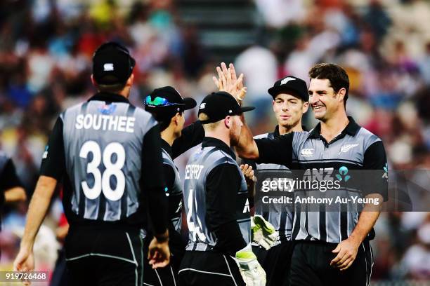 Colin de Grandhomme of New Zealand celebrates with teammates for the wicket of Dawid Malan of England during the International Twenty20 match between...