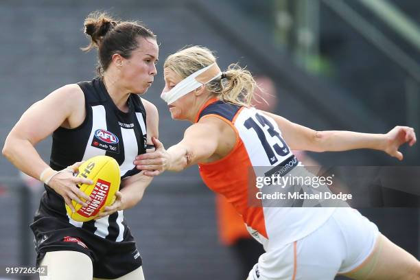 Tara Morgan of the Magpies runs with the ball past Cora Staunton of GWS during the round three AFLW match between the Collingwood Magpies and the...