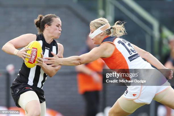 Tara Morgan of the Magpies runs with the ball past Cora Staunton of GWS during the round three AFLW match between the Collingwood Magpies and the...