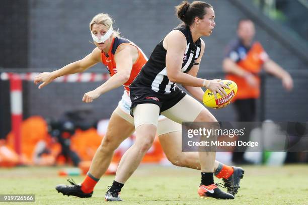 Tara Morgan of the Magpies runs with the ball past Cora Staunton of GWS during the round three AFLW match between the Collingwood Magpies and the...