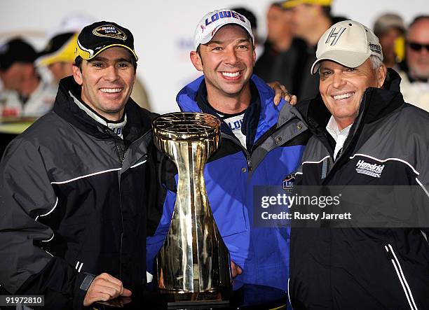 Jimmie Johnson, driver of the Lowe's Chevrolet, celebrates with his crew chief Chad Knaus and team owner Rick Hendrick after winning the NASCAR...
