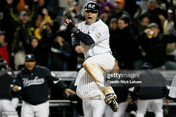 Jerry Hairston Jr. Of the New York Yankees celebrates scoring on a throwing error by Maicer Izturis of the Los Angeles Angels of Anaheim to win Game...