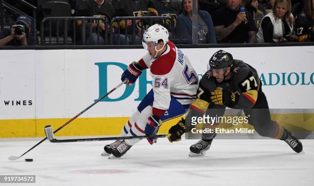 Charles Hudon of the Montreal Canadiens skates under pressure from Brad Hunt of the Vegas Golden Knights in the first period of their game at...