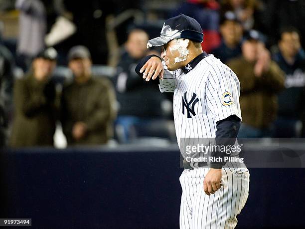 Jerry Hairston Jr. #17 of the New York Yankees wipes off a pie in the face after scoring the game-winning run in 13th inning of Game Two of the ALCS...