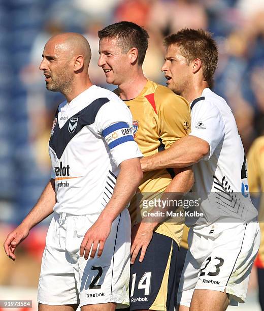 Michael Bridges of the Jets is heavily marked by Kevin Muscat and Adrian Leijer of the Victory during the round 11 A-League match between the...