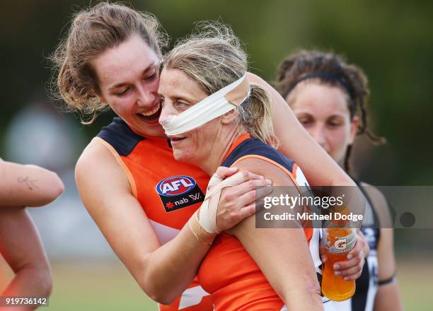 Cora Staunton of GWS celebrates the win after sustaining a nose injury with Erin McKinnon during the round three AFLW match between the Collingwood...