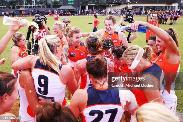 Giants players celebrate the win during the round three AFLW match between the Collingwood Magpies and the Greater Western Sydney Giants at Olympic...