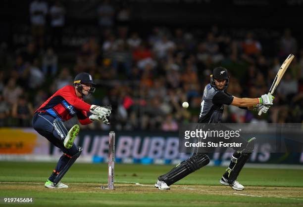 England wicketkeeper Jos Buttler looks on as Martin Guptill cuts towards the boundary during the International Twenty20 match between New Zealand and...