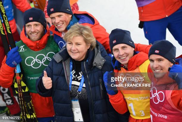 Norwegian prime Minister Erna Solberg poses for a photograph with gold winners Norway's Martin Johnsrud Sundby, Johannes Hoesflot Klaebo, Simen...