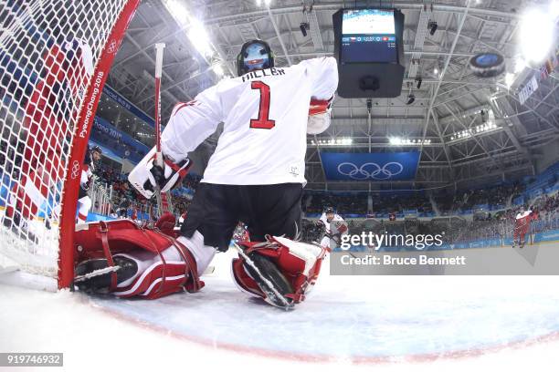 Jonas Hiller of Switzerland gives up a goal to Michal Repik of the Czech Republic in the first period during the Men's Ice Hockey Preliminary Round...