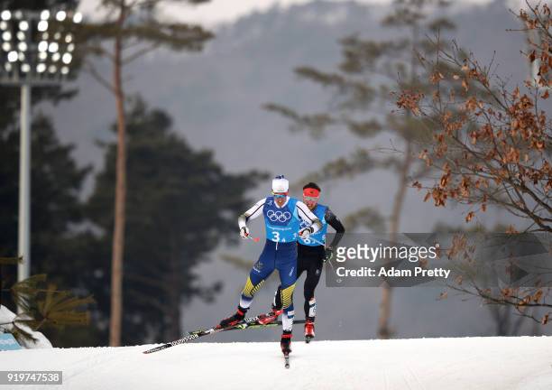 Calle Halfvarsson of Sweden and Jonas Dobler of Germany compete in the final leg during Cross-Country Skiing men's 4x10km relay on day nine of the...