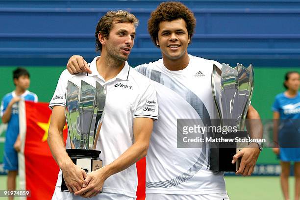Julien Benneteau and Jo-Wilfried Tsonga of France pose after defeating Mariusz Fyrstenberg and Marcin Matkowski of Poland during the doubles final on...