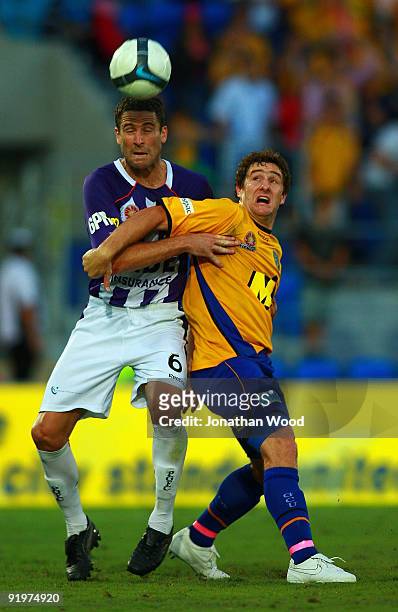Joel Porter of United contests the ball with Chris Coyne of the Glory during the round 11 A-League match between Gold Coast United and Perth Glory at...