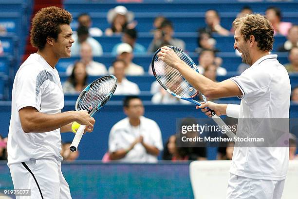 Jo-Wilfried Tsonga and Julien Benneteau of France celebrate match point against Mariusz Fyrstenberg and Marcin Matkowski of Poland during the doubles...
