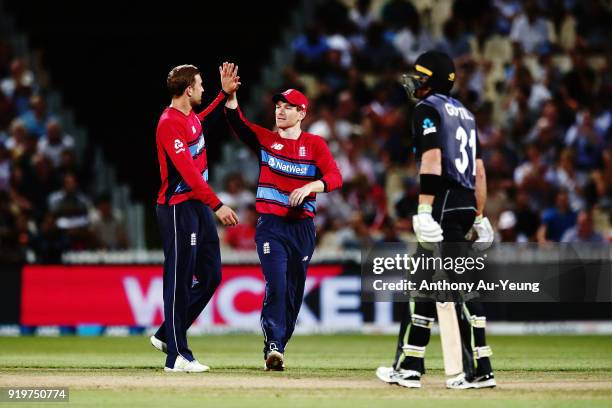 Eoin Morgan and Dawid Malan of England celebrate the wicket of Martin Guptill of New Zealand during the International Twenty20 match between New...