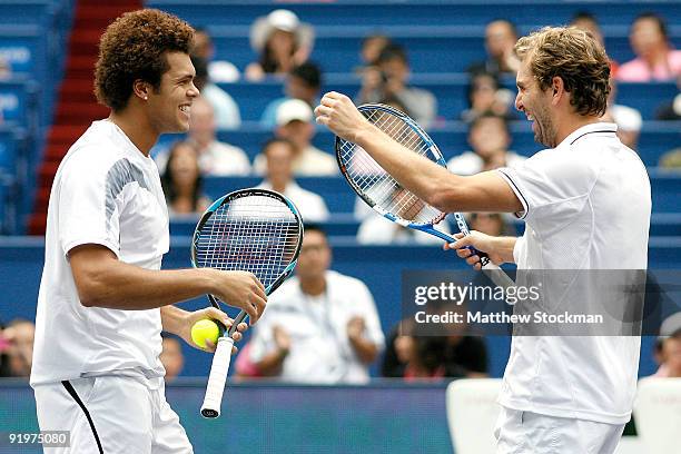 Jo-Wilfried Tsonga and Julien Benneteau of France celebrate match point against Mariusz Fyrstenberg and Marcin Matkowski of Poland during the doubles...