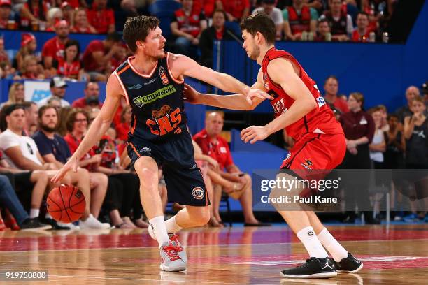 Cameron Gliddon of the Taipans controls the ball against Clint Steindl of the Wildcats during the round 19 NBL match between the Perth Wildcats and...