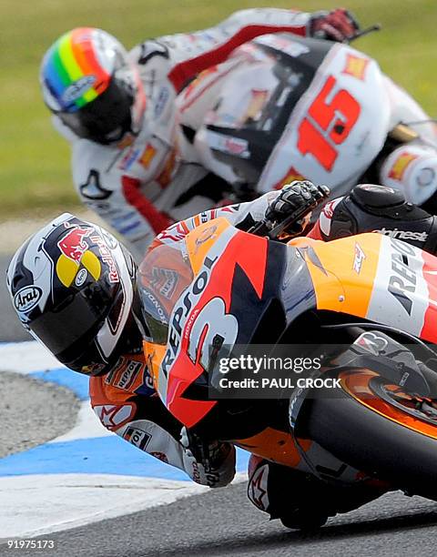 Dani Pedrosa of Spain leans his Honda into a corner ahead of Alex de Angelis of San Marino during the Australian MotoGP Grand Prix at Phillip Island...