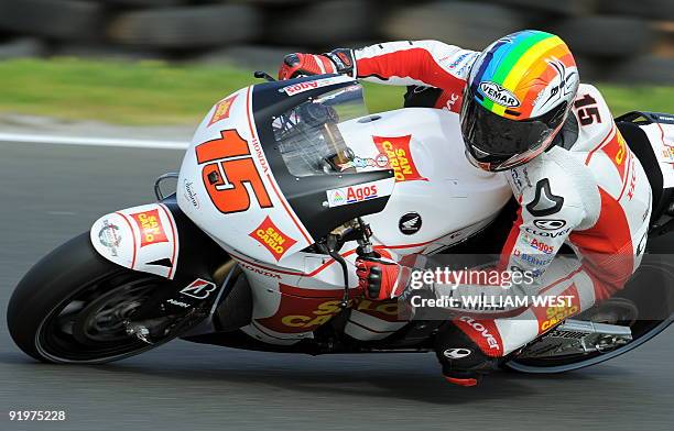Alex de Angelis of San Marino speeds through a corner on his Honda on the way to fourth place in the MotoGP at the Australian Motorcycle Grand Prix...