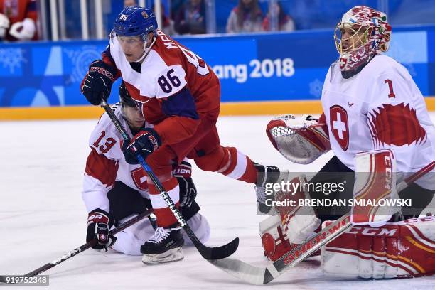 Czech Republic's Tomas Mertl skates between Switzerland's Felicien Du Bois and Jonas Hiller in the men's preliminary round ice hockey match between...