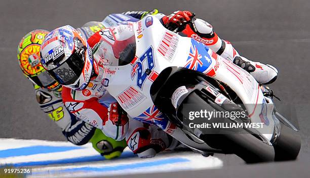 Casey Stoner of Australia on a Ducati leads Valentino Rossi of Italy during the MotoGP at the Australian Motorcycle Grand Prix at Phillip Island,...