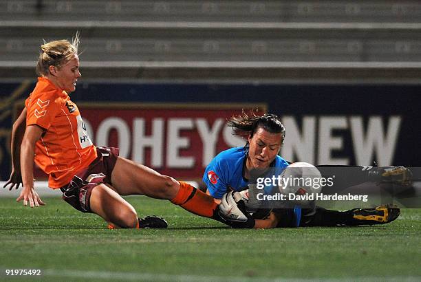 Tameka Butt of the Roar and goal keeper Jillian Loyden of the Mariners compete for the ball during the round three W-League match between the...