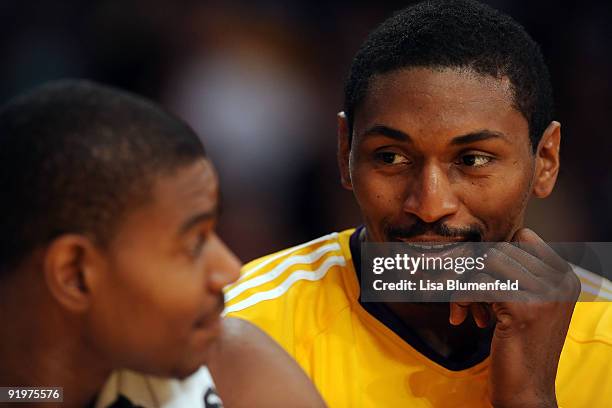 Ron Artest of the Los Angeles Lakers talks with teammate Andrew Bynum during a preseason game against the Charlotte Bobcats at Staples Center on...