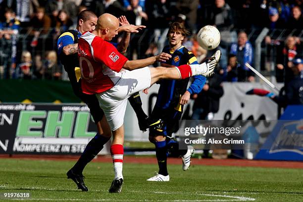 Nils-Ole Book of Ahlen kicks the ball ahead of Christian Mueller of Koblenz during the Second Bundesliga match between TuS Koblenz and Rot-Weiss...