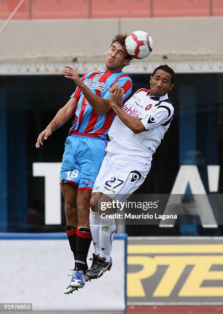 Blazej Augustyn of Catania Calcio is challenged by Capucho Neves Jeda of Cagliari Calcio during the Serie A match between Catania Calcio and Cagliari...