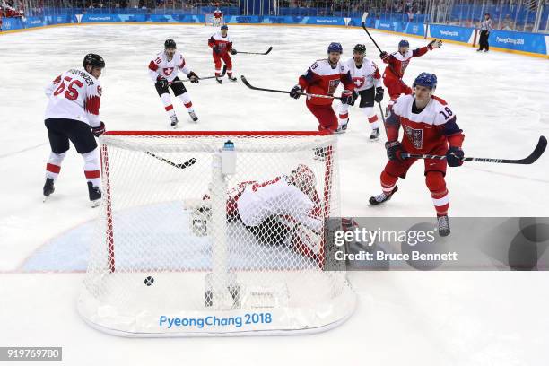 Dominik Kubalik of the Czech Republic scores a goal on Jonas Hiller of Switzerland in the third period during the Men's Ice Hockey Preliminary Round...