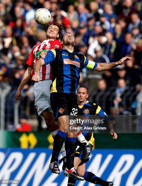 Shefki Kuqi of Koblenz jumps for a header with Nils Doering of Ahlen during the Second Bundesliga match between TuS Koblenz and Rot-Weiss Ahlen at...