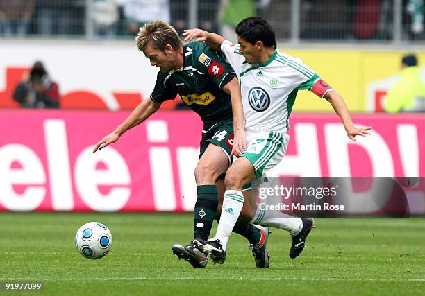 Josue of Wolfsburg and Thorben Marx of Gladbach battle for the ball during the Bundesliga match between VfL Wolfsburg and Borussia M'gladbach at the...