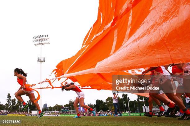 Players break through the banner during the round three AFLW match between the Collingwood Magpies and the Greater Western Sydney Giants at Olympic...