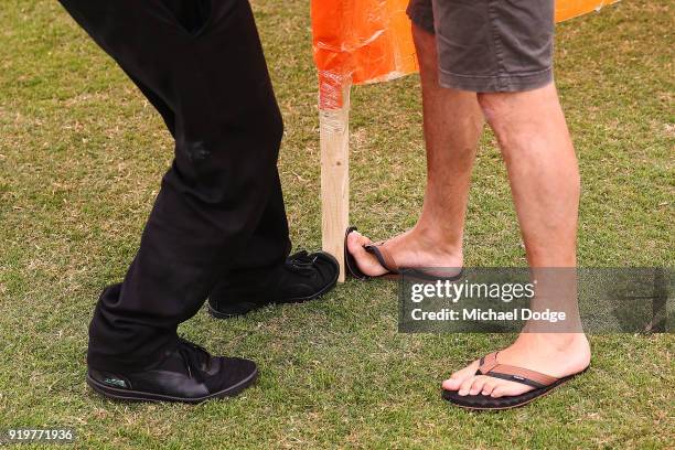 Cheersquad members keep the banner still with their feet during the round three AFLW match between the Collingwood Magpies and the Greater Western...