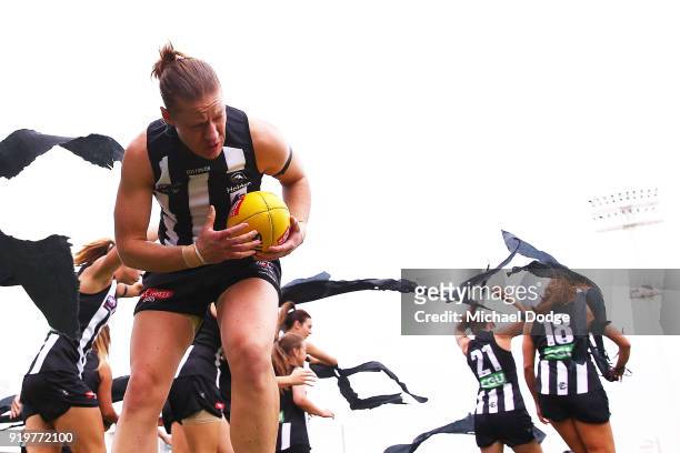 Meg Hutchins of the Magpies breaks through the banner during the round three AFLW match between the Collingwood Magpies and the Greater Western...