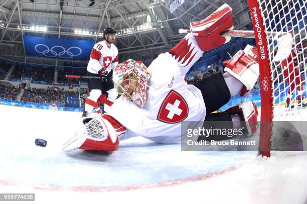Jonas Hiller of Switzerland gives up a goal to Dominik Kubalik of the Czech Republic in the third period during the Men's Ice Hockey Preliminary...
