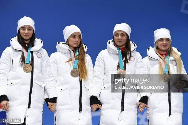 Russia's bronze medallists Natalia Nepryaeva, Yulia Belorukova, Anastasia Sedova and Anna Nechaevskaya pose on the podium during the medal ceremony...