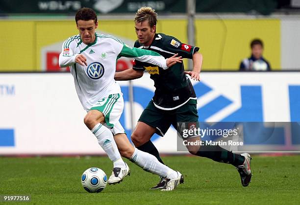 Christian Gentner of Wolfsburg and Thorben Marx of Gladbach battle for the ball during the Bundesliga match between VfL Wolfsburg and Borussia...