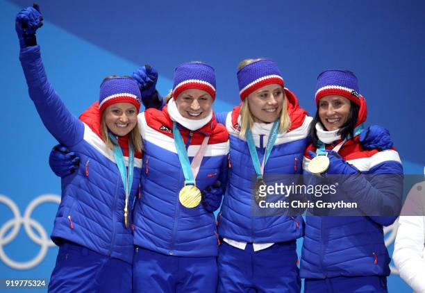 Gold medalists Ingvild Flugstad Oestberg, Astrid Uhrenholdt Jacobsen, Ragnhild Haga and Marit Bjoergen of Norway celebrate during the medal ceremony...