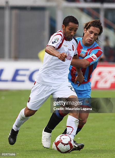 Capucho Neves Jeda of Cagliari Calcio is challenged by Matias Silvestre of Catania Calcio during the Serie A match played between Catania Calcio and...