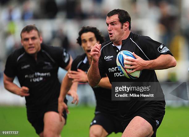 Carl Hayman of Newcastle has plenty of support as he goes on the charge during the Amlin Challenge Cup match between Newcastle Falcons and Albi at...