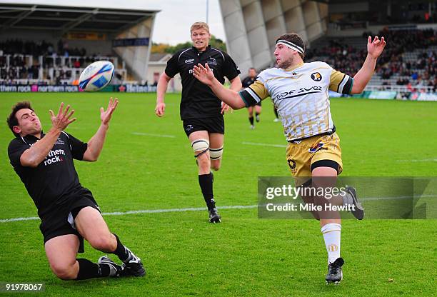 Alex Walker of Newcastle takes a cross field kick to score a try as Clement Maynadier of Aldi looks on during the Amlin Challenge Cup match between...