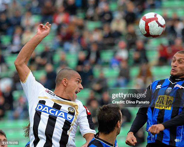 Gokhan Inler of Udinese Calcio competes in the air with Tiberio Guarente of Atalanta BC during the Serie A match between Udinese Calcio and Atalanta...