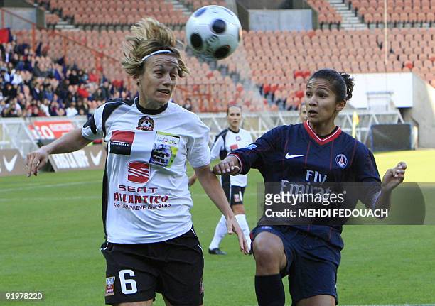 French women football team Juvisy defender Sandrine Soubeyrand kicks off the ball next to Paris Saint-Germain Zohra Ayachi during their French...