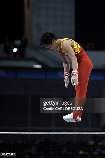 China's Zou Kai performs in the high bar event in the apparatus finals during the Artistic Gymnastics World Championships 2009 at the 02 Arena, in...