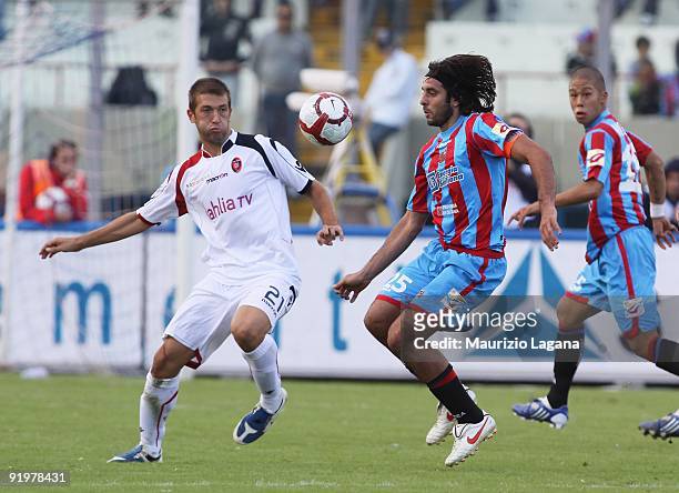 Jorge Martinez of Catania Calcio competes for the ball with Michele Canini of Cagliari Calcio during the Serie A match between Catania Calcio and...
