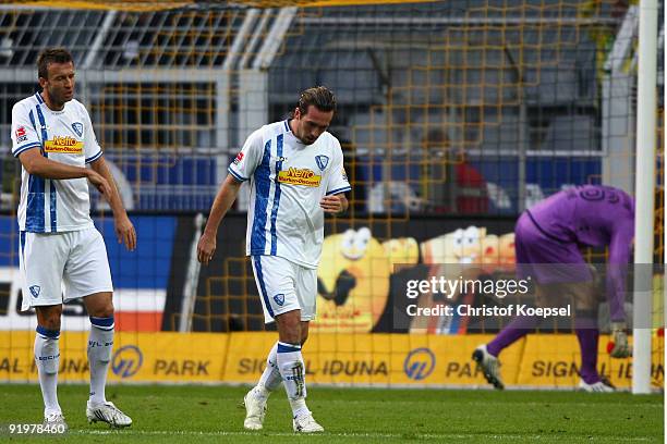 Christoph Dabrowski, Christian Fuchs and Andreas Luthe of Bochum look dejected after the first goal for Dortmund during the Bundesliga match between...