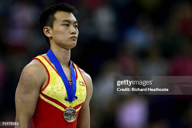 Guanyin Wang of China poses with his gold medal after he won the parallel bars during the Apparatus Finals on the sixth day of the Artistic...